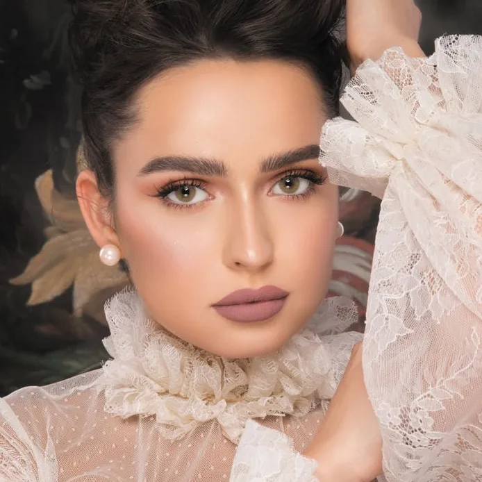 Model wearing Naturèl Core Jade colored contact lenses